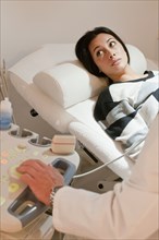 Hispanic woman having sonogram examination