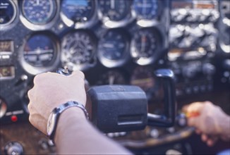 Pilot handling controls close-up (focus on hand)