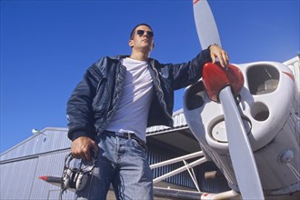 Pilot Standing by a Propeller Aeroplane