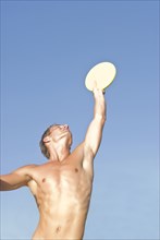 young man catching frisbee