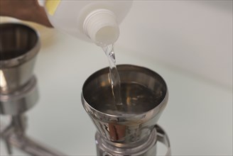 liquid being poured into measuring instrument
