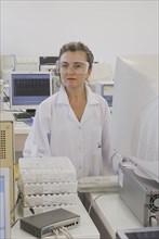 Lab technician standing at counter in laboratory