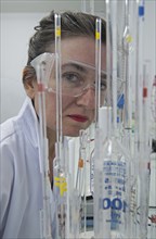 laboratory technician behind test tubes