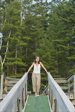 mature woman on wooden walkway