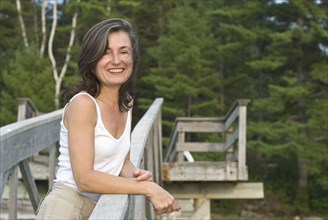smiling woman on wooden walkway