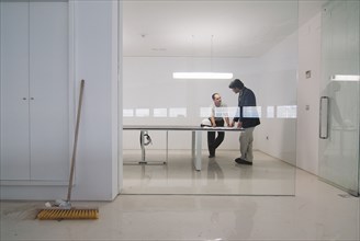 Two men in conference room of new office