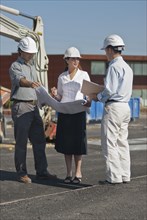 female and male architects in construction site