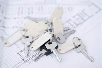 a bundle of keys lying on an architect's plan