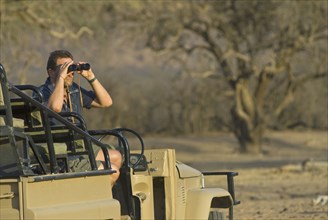 tourist on safari watching wildlife
