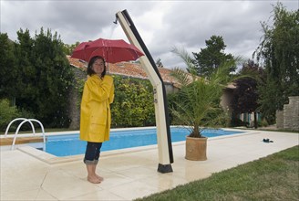 woman with unbrella under outdoor shower