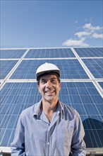 engineer in front of solar panels