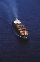 Aerial view of shipping barge sailing on ocean