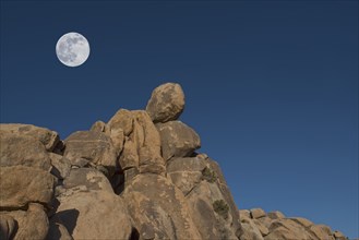 Full moon above rock formation