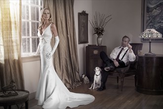 Caucasian bride and groom in study with dogs