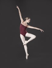 Caucasian ballet dancer posing on pointe