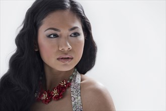 Asian woman wearing flower necklace