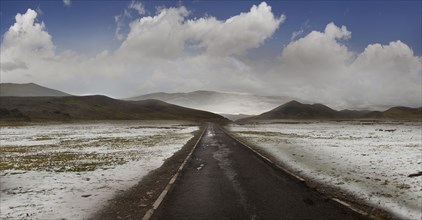 Empty road in snowy rural landscape