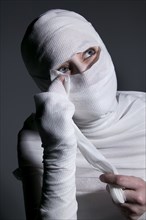 Woman unwrapping mummy costume