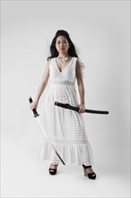 Asian woman holding sword