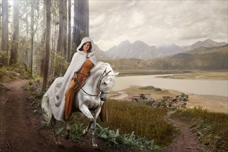 Caucasian woman riding horse in remote forest