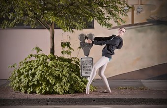 Caucasian ballet dancer posing with parking meter