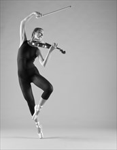 Caucasian ballet dancer playing violin