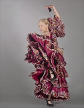 Caucasian woman dancing in ornate dress