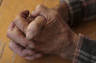 Hands of older man clasped