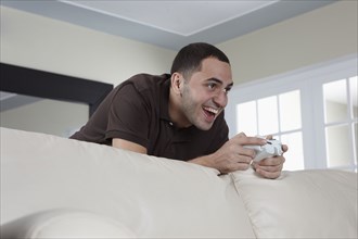 Hispanic man playing video game