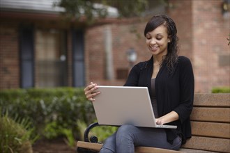 Mixed race woman typing on laptop
