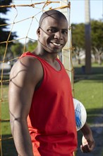 Black man holding soccer ball