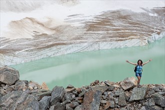 Hispanic woman hiking hear glacial lake