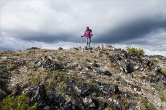 Hispanic woman hiking on mountain