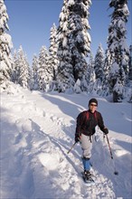 Hispanic woman snowshoeing in remote area