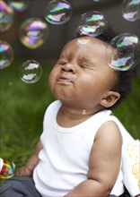 African American boy playing with bubbles