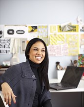 Smiling businesswoman sitting at desk