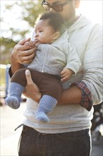 Father holding African American baby boy