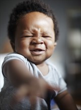 Grimacing African American baby