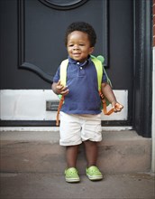 African American baby wearing backpack