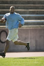 Man running with football