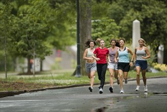 Runners jogging in park
