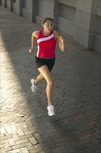 Woman jogging on sidewalk