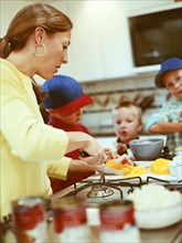 Caucasian mother and sons preparing food