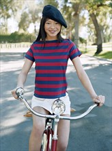 Woman riding bicycle with beret