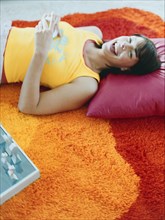 Woman laying on pillow on floor