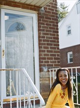 Woman sitting on front stoop