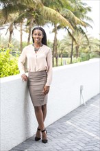 Smiling African American businesswoman standing outdoors