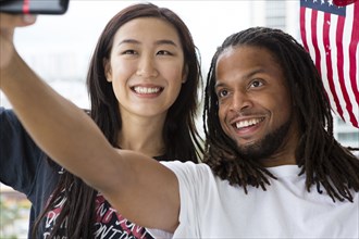 Couple taking selfie with American flag