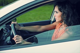 Angry Caucasian woman driving car