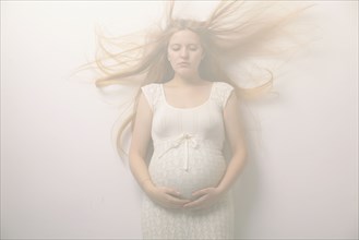 Pregnant woman with windblown hair